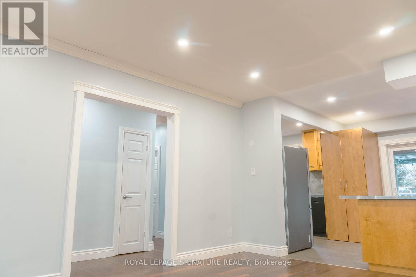 A white room with a doorway leading to another room.