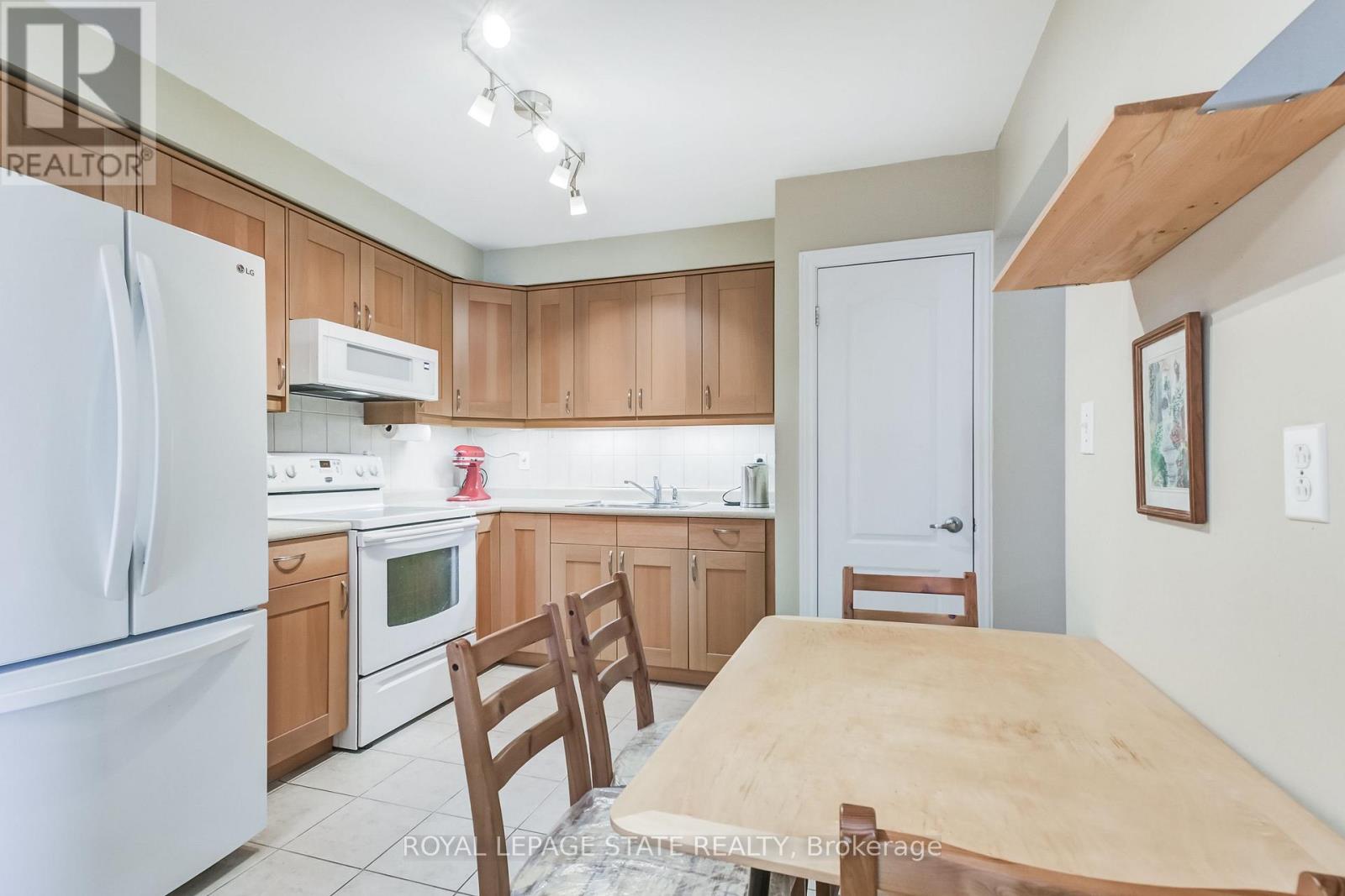 A kitchen with a table and chairs.
