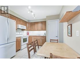 A kitchen with a table and chairs.