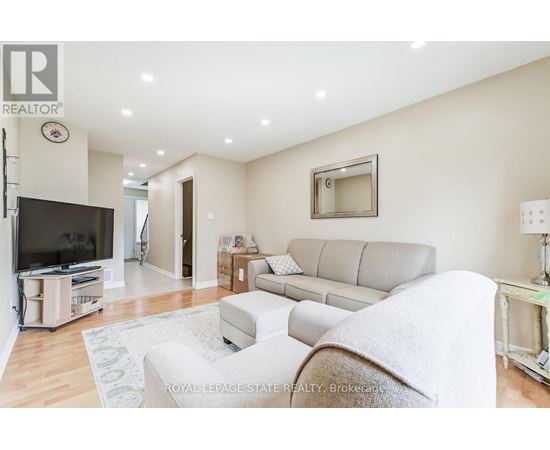 A living room with a grey couch and a television.
