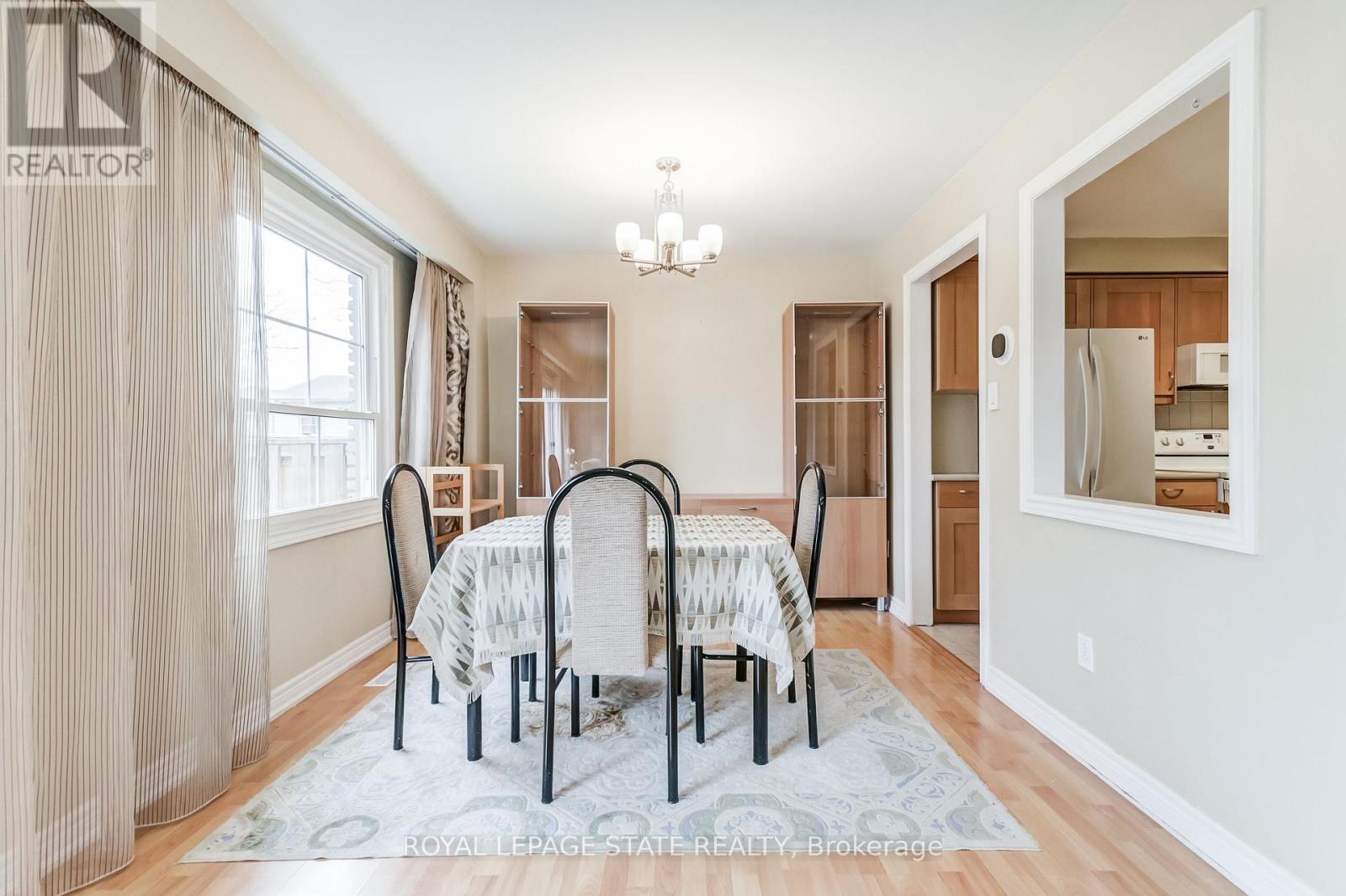 A dining room with a table set for four.