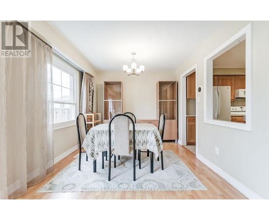 A dining room with a table set for four.