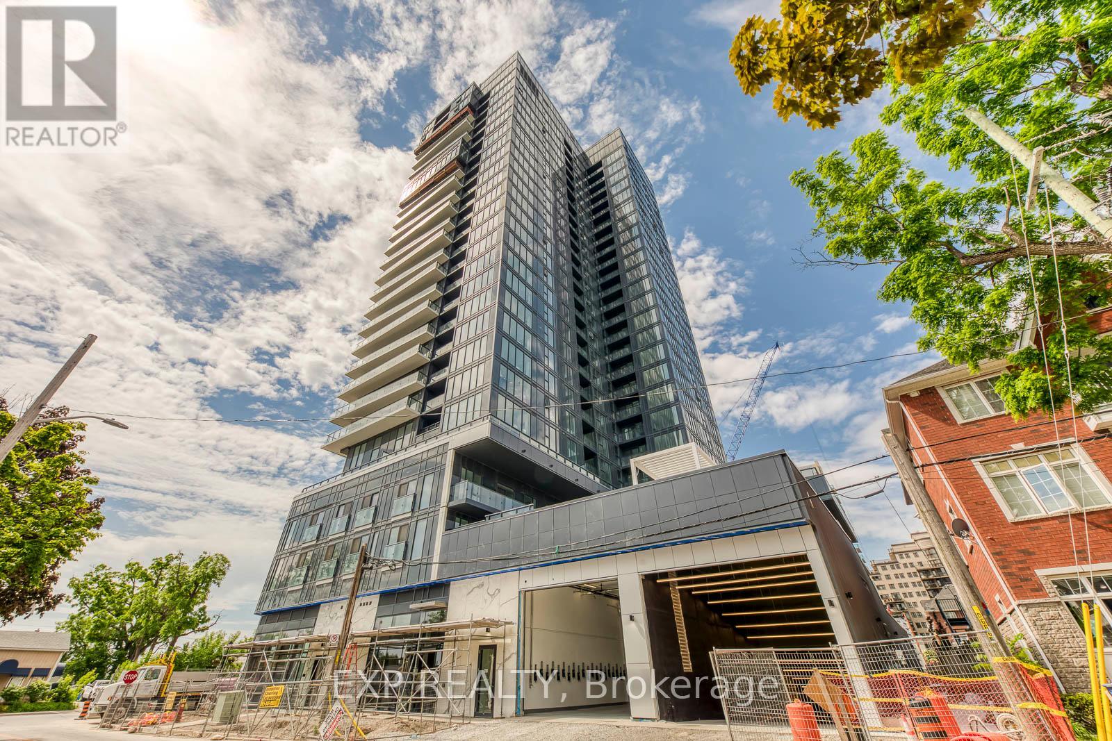 A modern building under construction with a clear sky in the background.