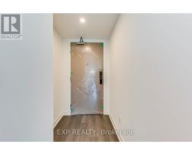 A room with a door covered in plastic and a REALTOR® logo on the wall.