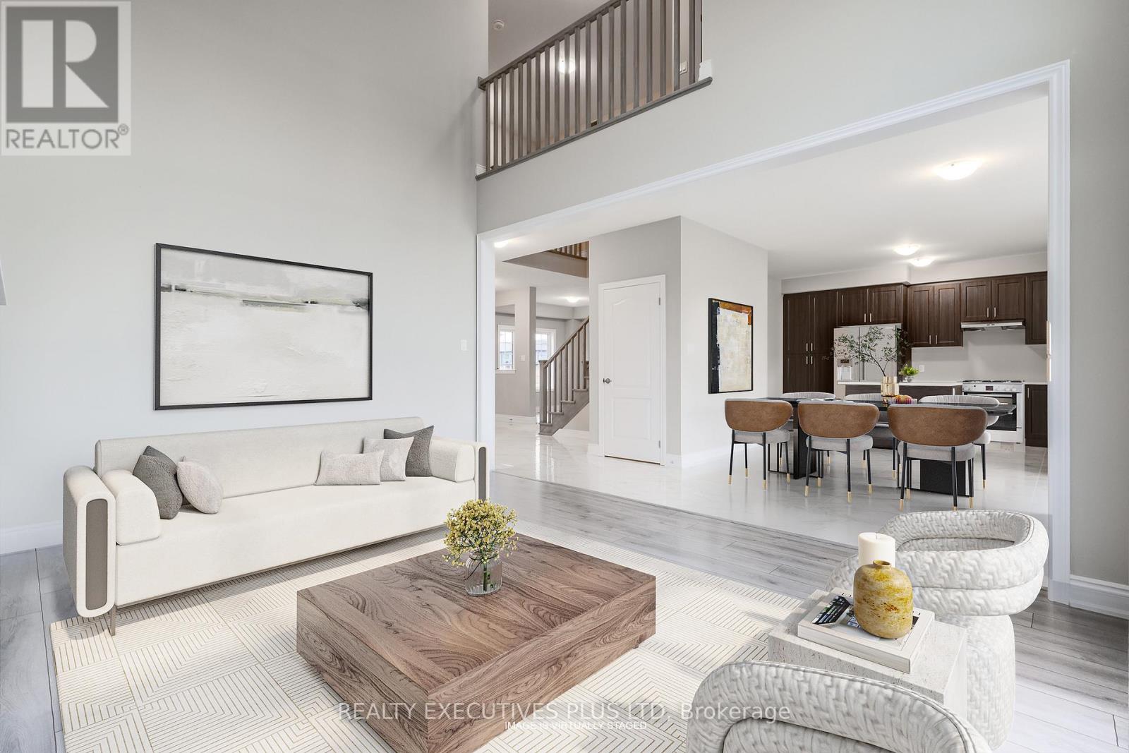 A living room with a white couch and a wooden coffee table.