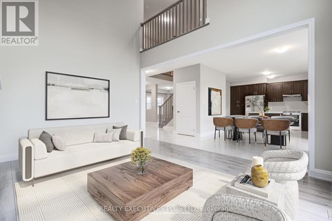 A living room with a white couch and a wooden coffee table.