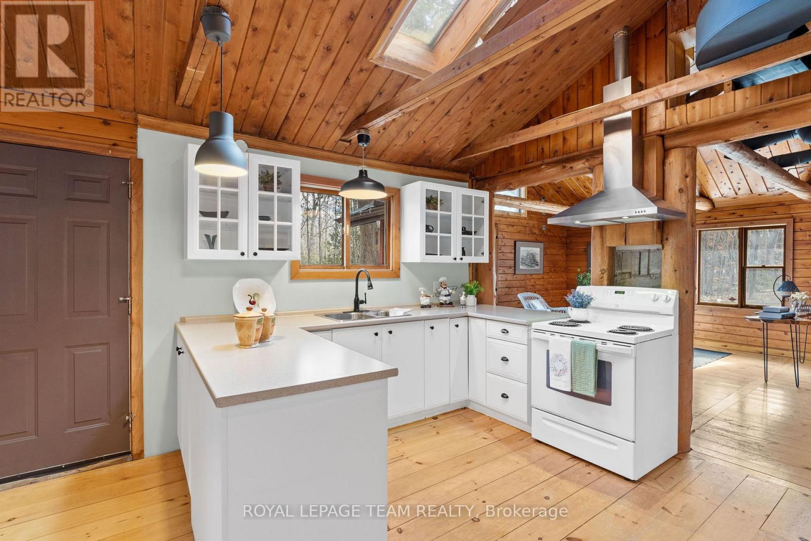 A kitchen with wooden cabinets and a white island.