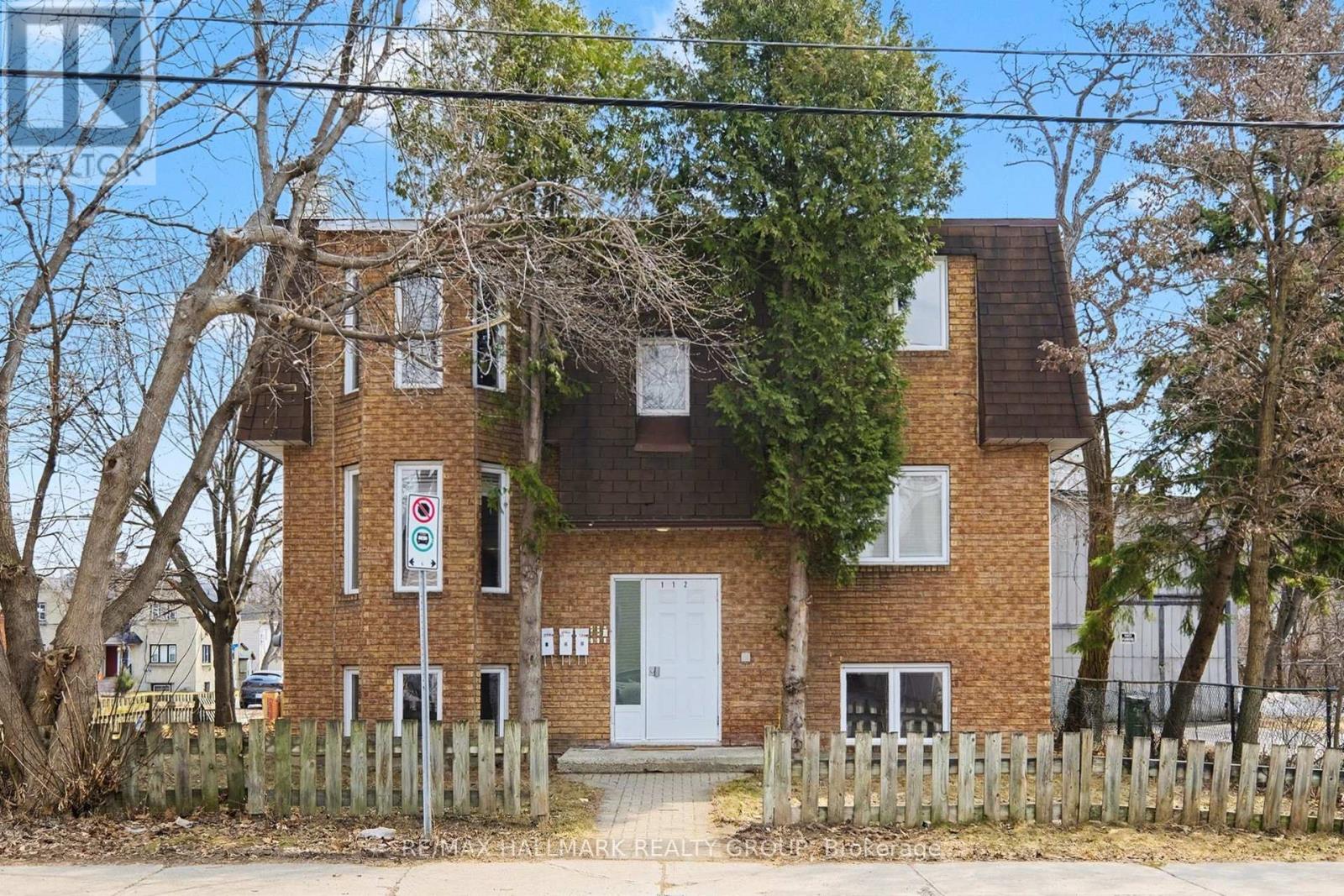 A house with a white door and a sign in front of it.