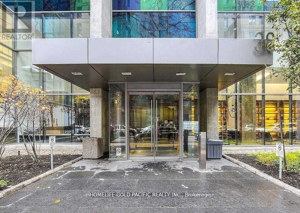 The front of a building with glass windows and a sign that says "HomeLife Gold Pacific Realty Inc. Brokerage.".