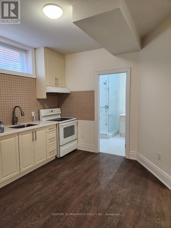 A kitchen with wooden floors and white appliances.