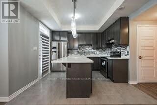A modern kitchen with dark wood cabinets and a central island.