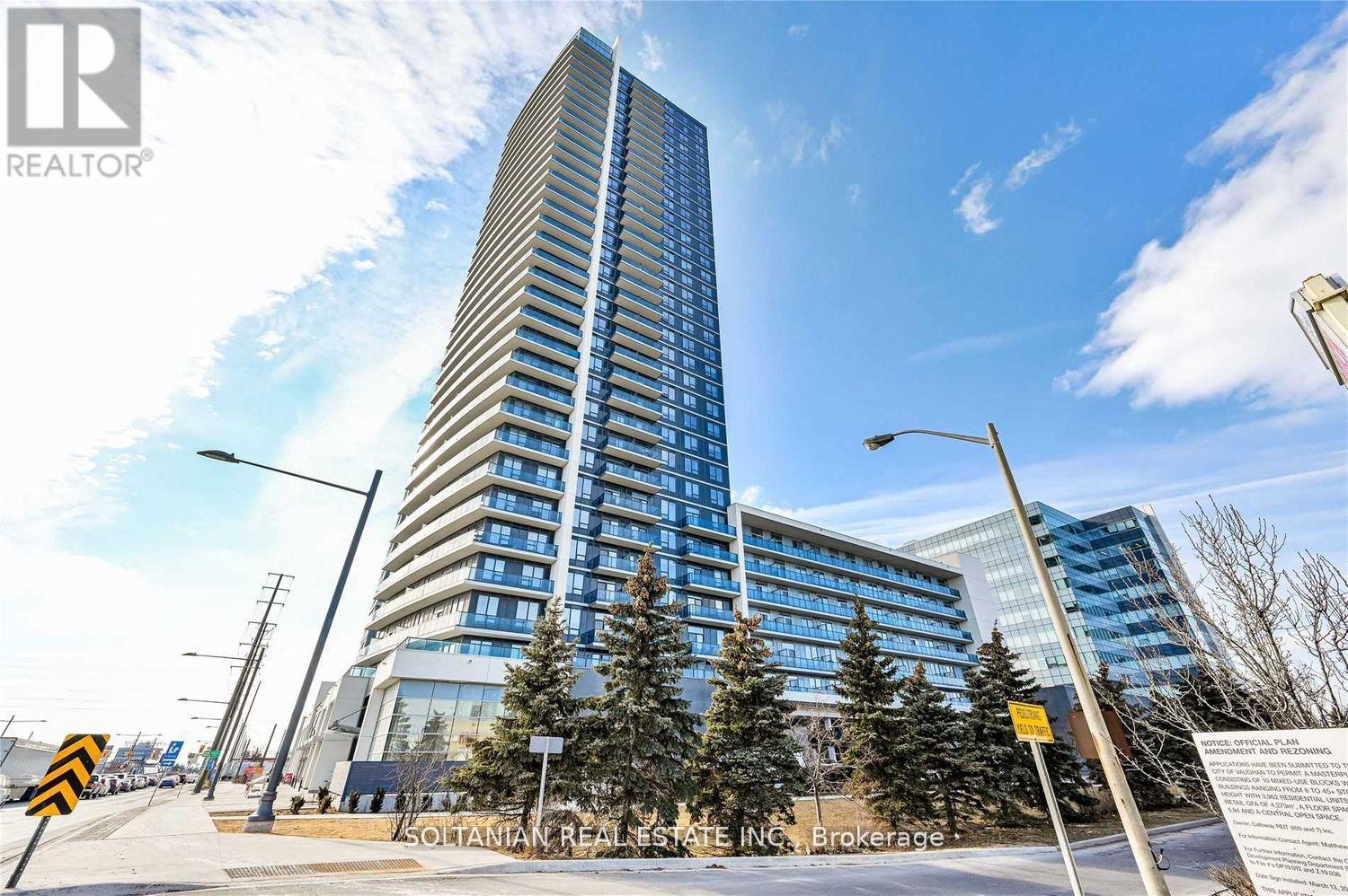 A tall building with a blue sky in the background.