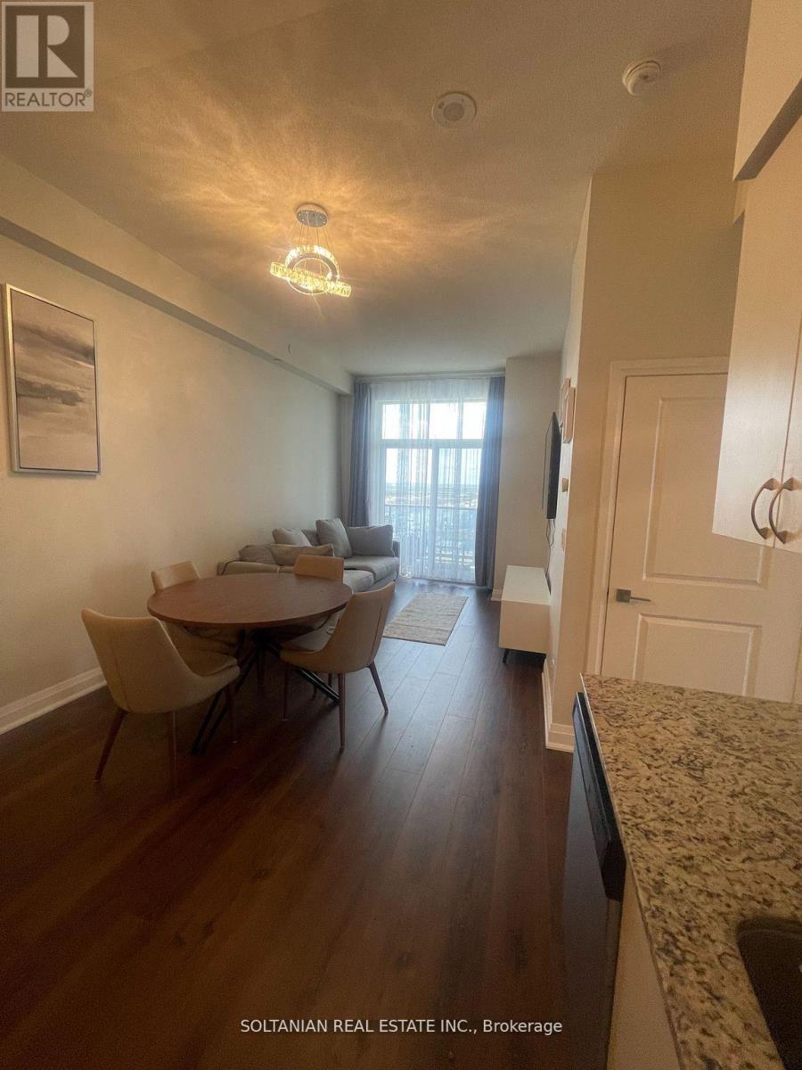 A dining room with a table and chairs.