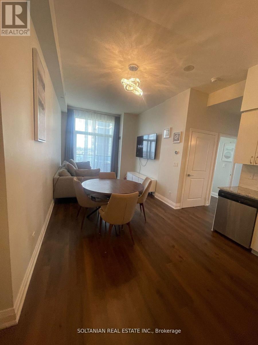 A living room with a dining table and chairs.