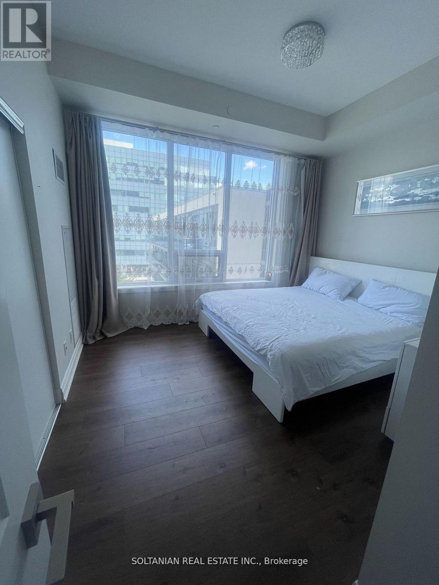 A bedroom with a large bed and a view of the city.