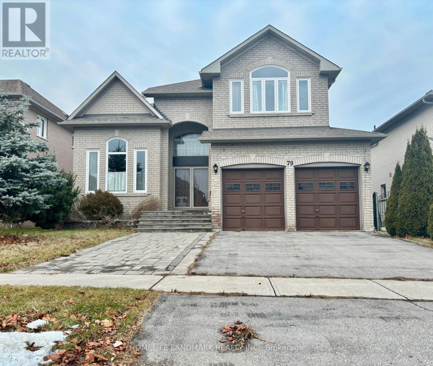 A large house with a driveway in front.