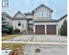 A large house with a driveway in front.