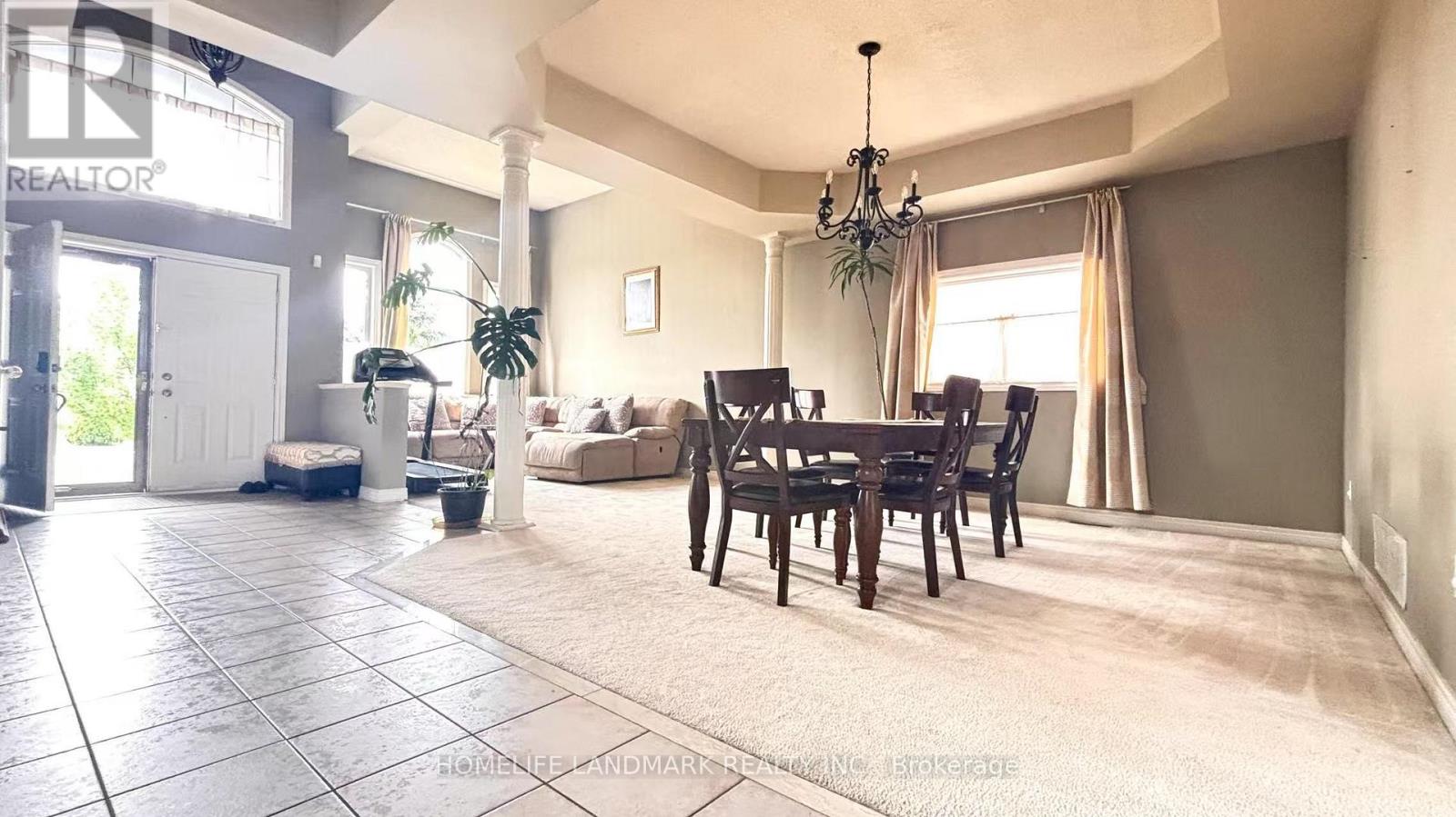 A living room with a dining table and chairs.