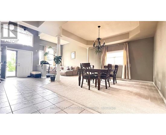 A living room with a dining table and chairs.