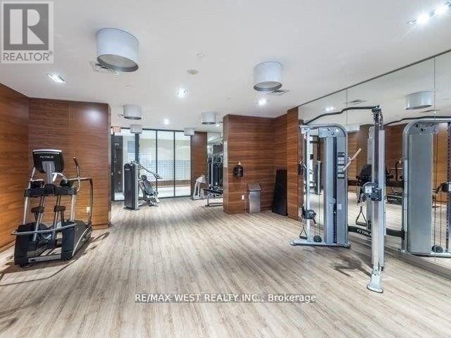 A gym with wooden floors and various exercise equipment.