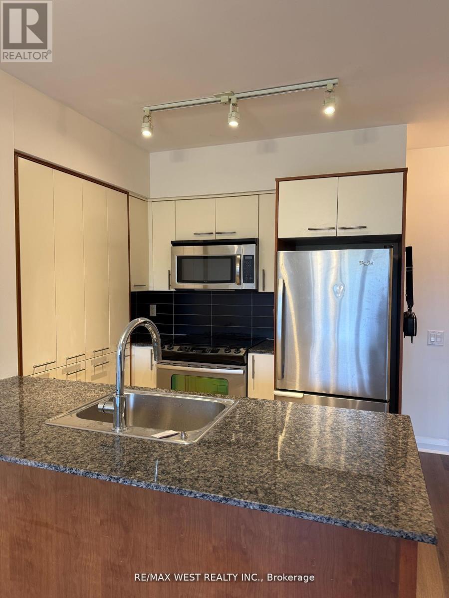 A kitchen with granite countertops and stainless steel appliances.