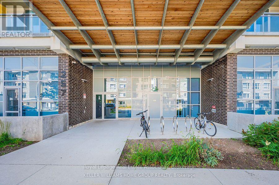 A building entrance with a bicycle parked in front.