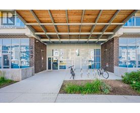 A building entrance with a bicycle parked in front.