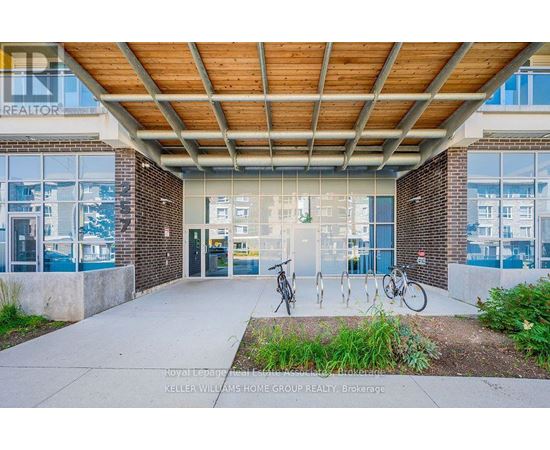 A building entrance with a bicycle parked in front.