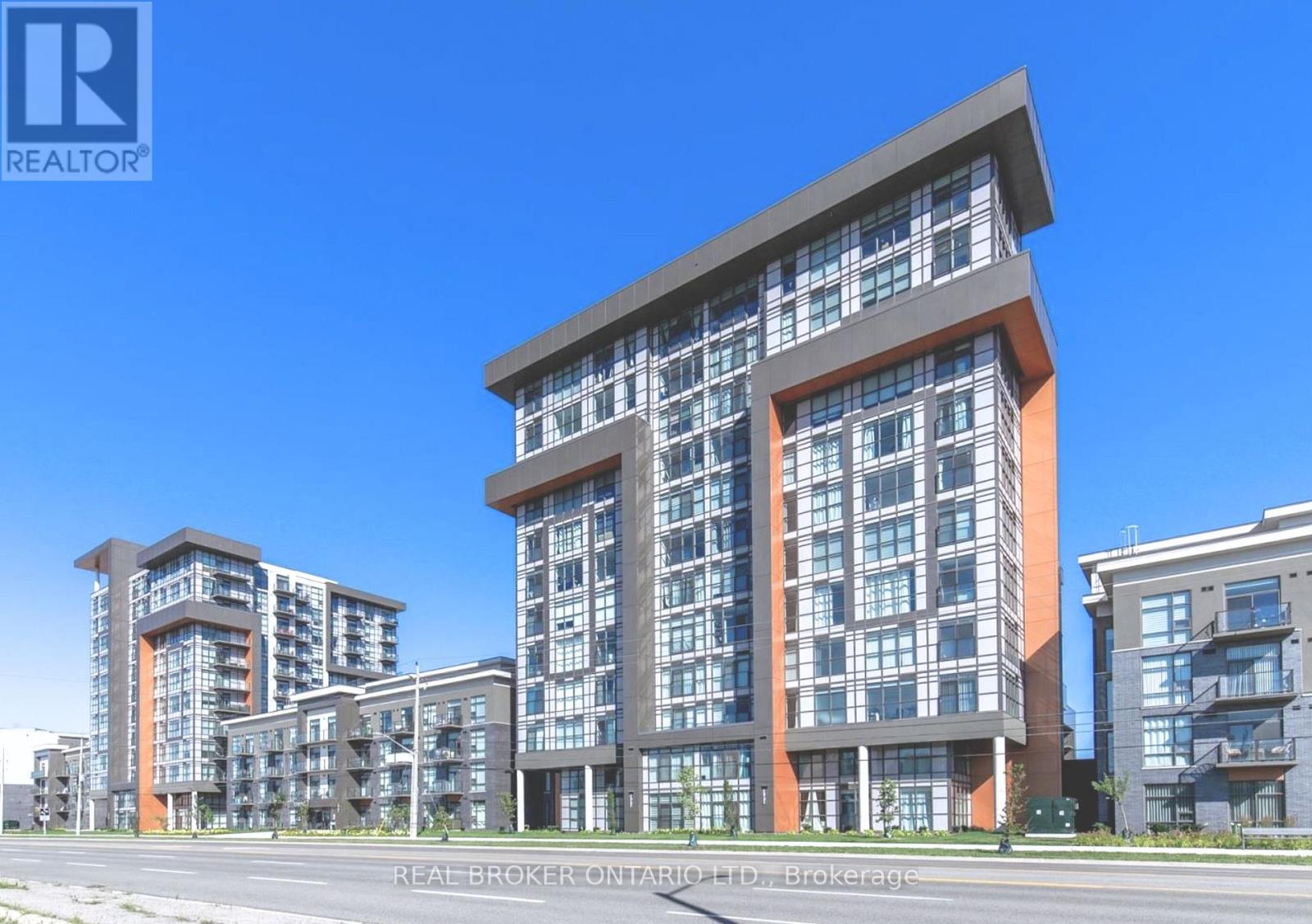 A modern multi-story residential building with a clear blue sky in the background.