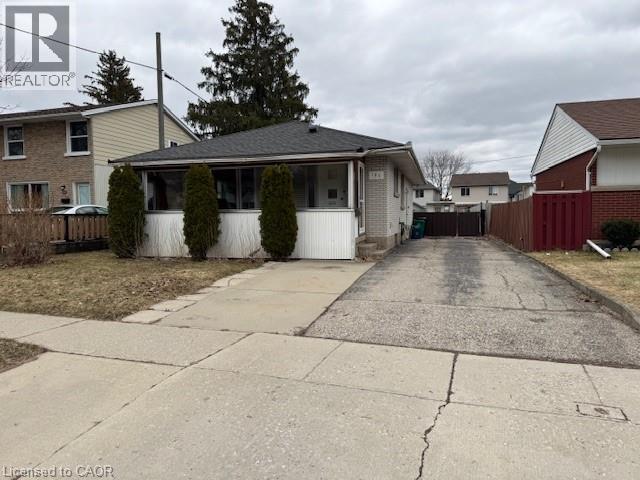A residential area with houses and a driveway.