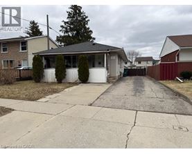 A residential area with houses and a driveway.