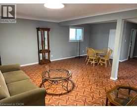 A living room with a brown sofa, a coffee table, and a wooden floor.