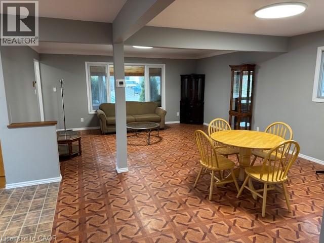 A dining room with a yellow table and chairs.