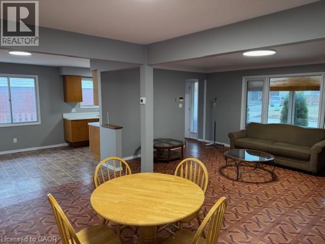 A living room with a dining table and chairs.