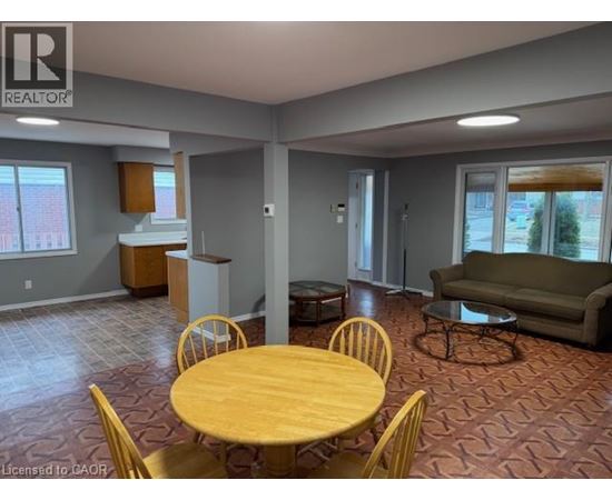 A living room with a dining table and chairs.
