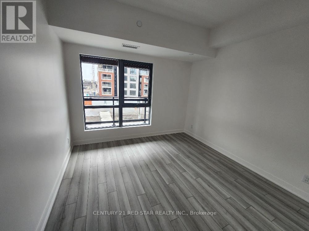 A room with a window showing a view of a building outside.