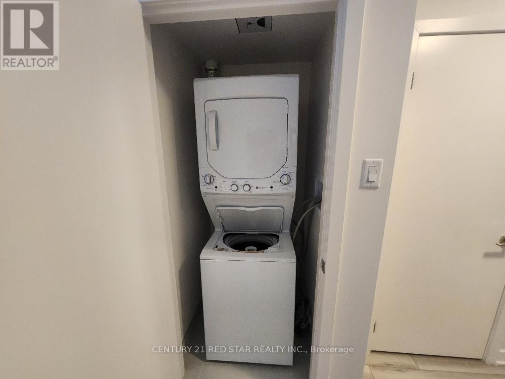 A white washing machine is tucked into a small space in a home.