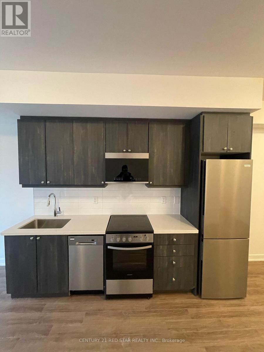 A modern kitchen with dark wood cabinets and stainless steel appliances.