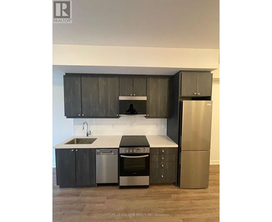 A modern kitchen with dark wood cabinets and stainless steel appliances.
