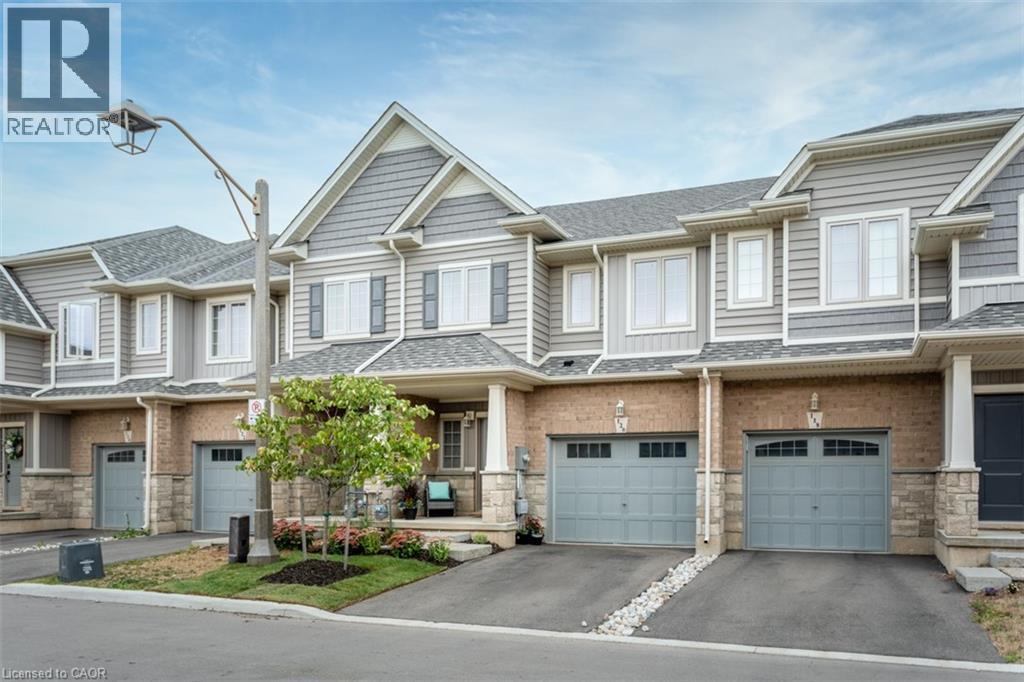 A row of houses with garages in front.
