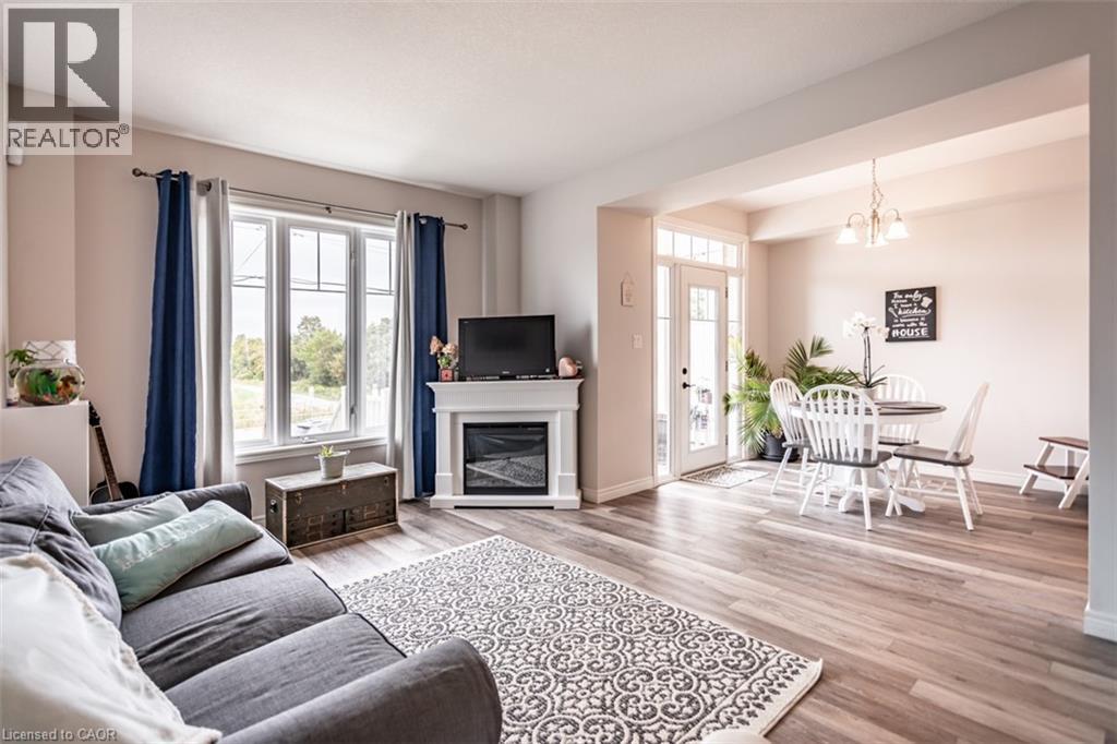 A living room with a grey sofa and a fireplace.