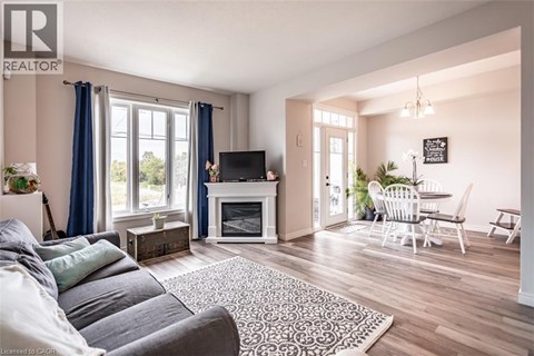A living room with a grey sofa and a fireplace.
