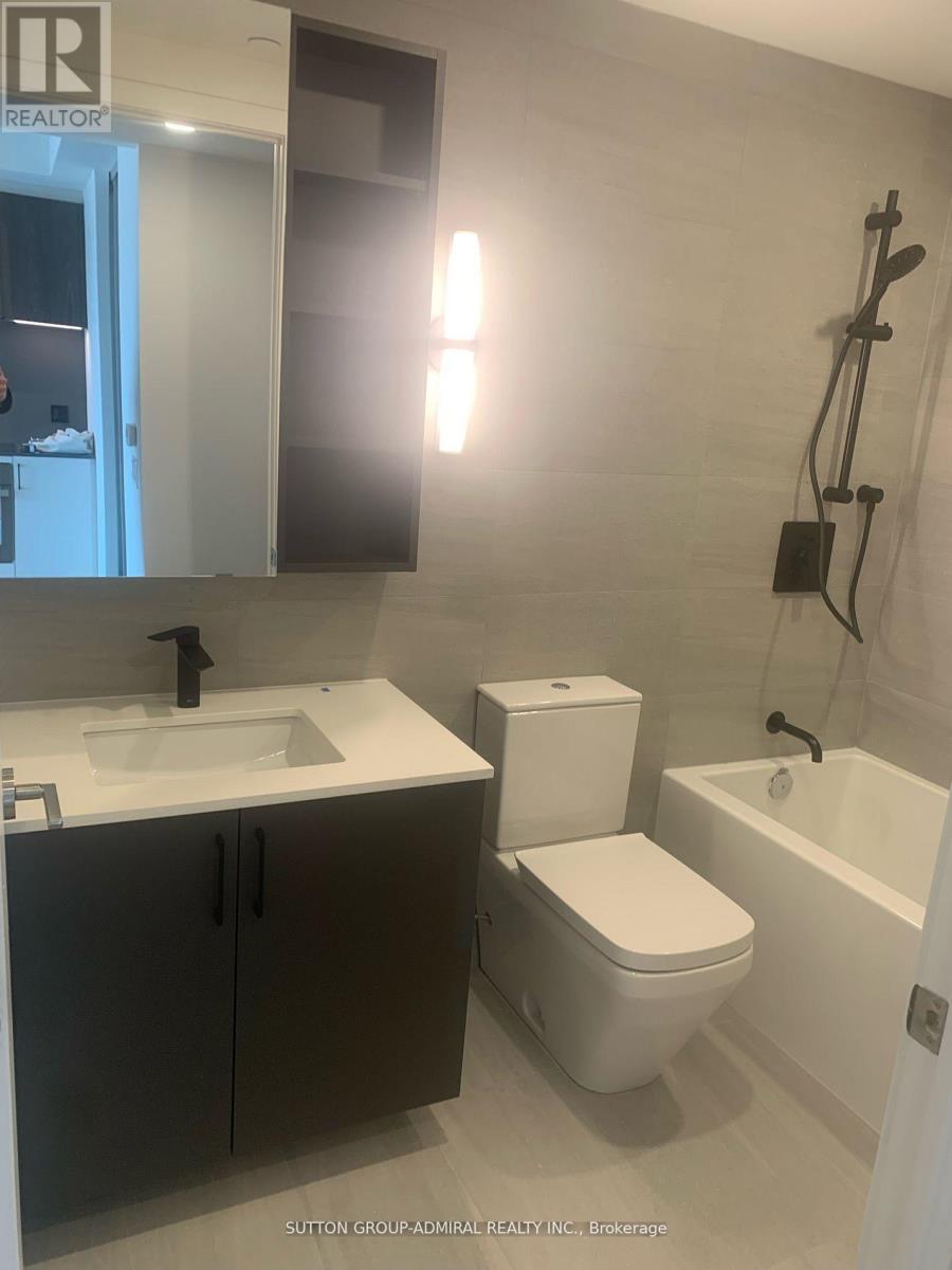 A bathroom with a sink, toilet and bathtub.