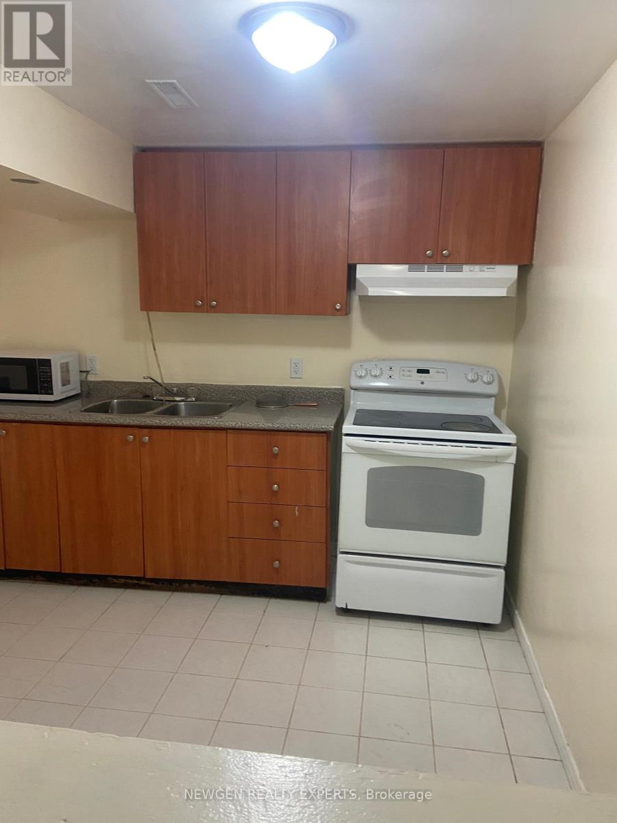 A kitchen with a white oven and microwave.