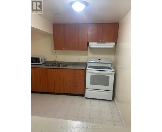 A kitchen with a white oven and microwave.
