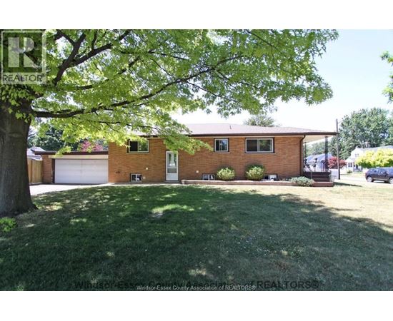 A house with a lawn in front of it.