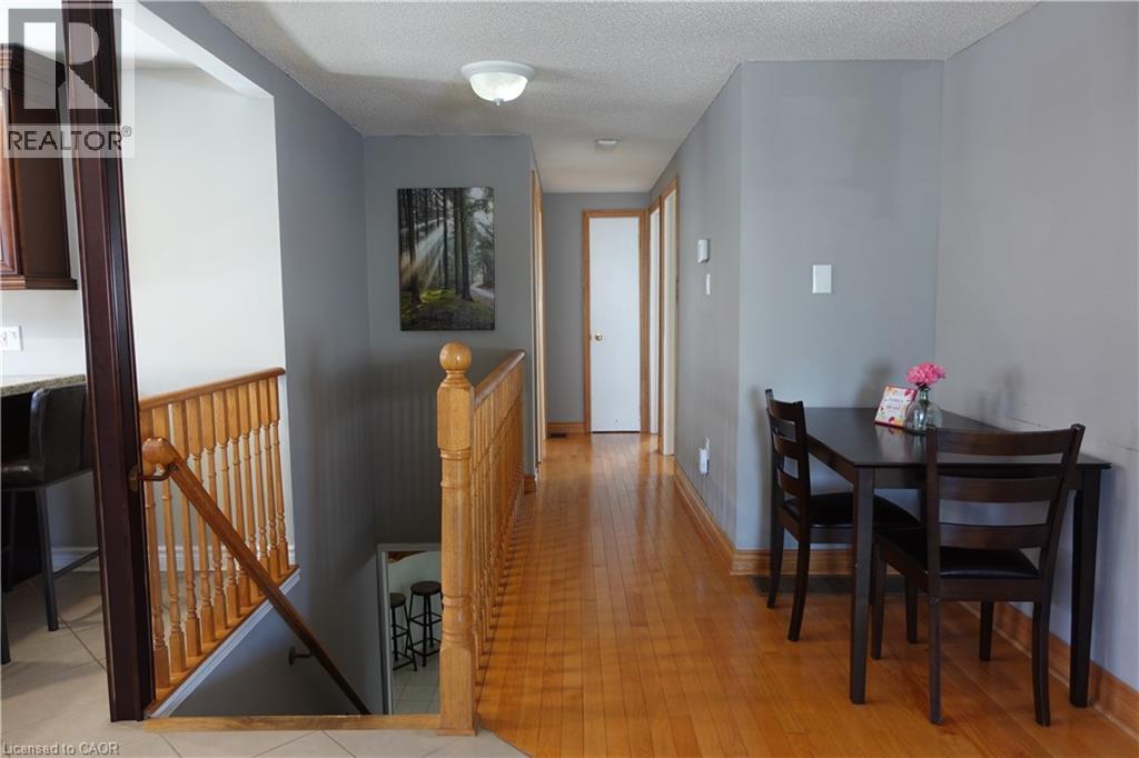 A dining room with a wooden table and chairs.