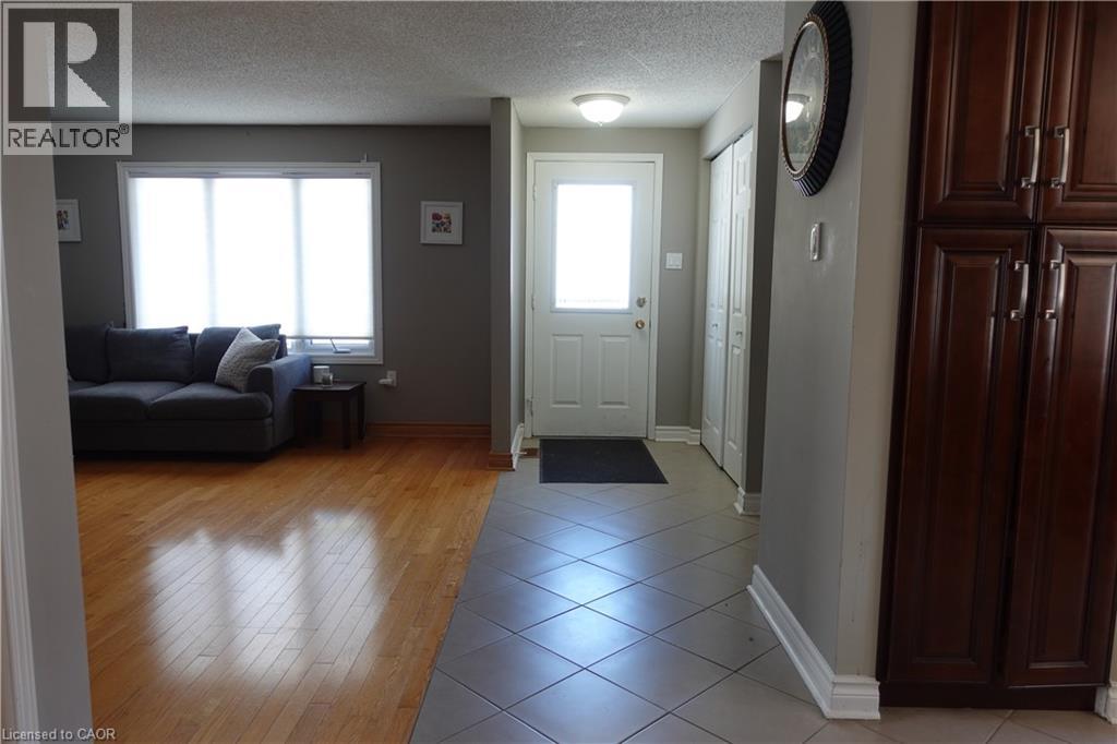 A living room with a grey couch and a wooden floor.