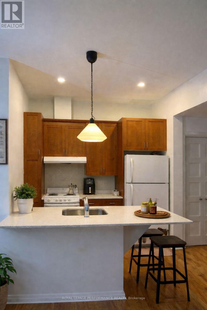 A kitchen with a white countertop and wooden cabinets.