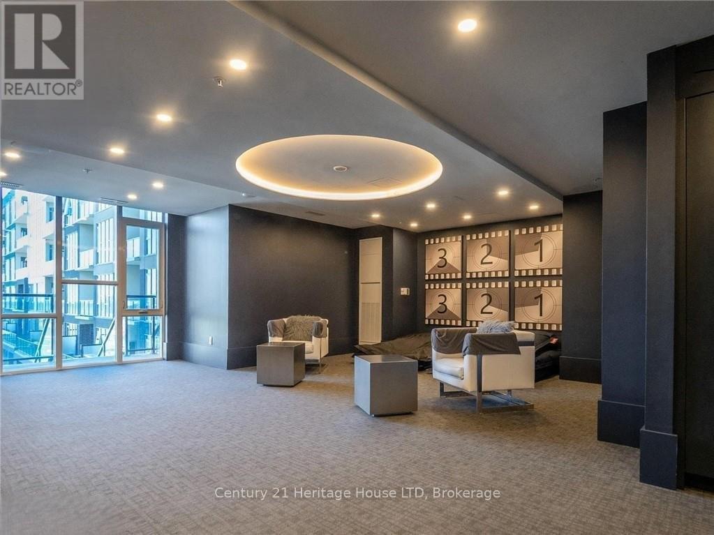 A spacious room with a large window and a seating area.